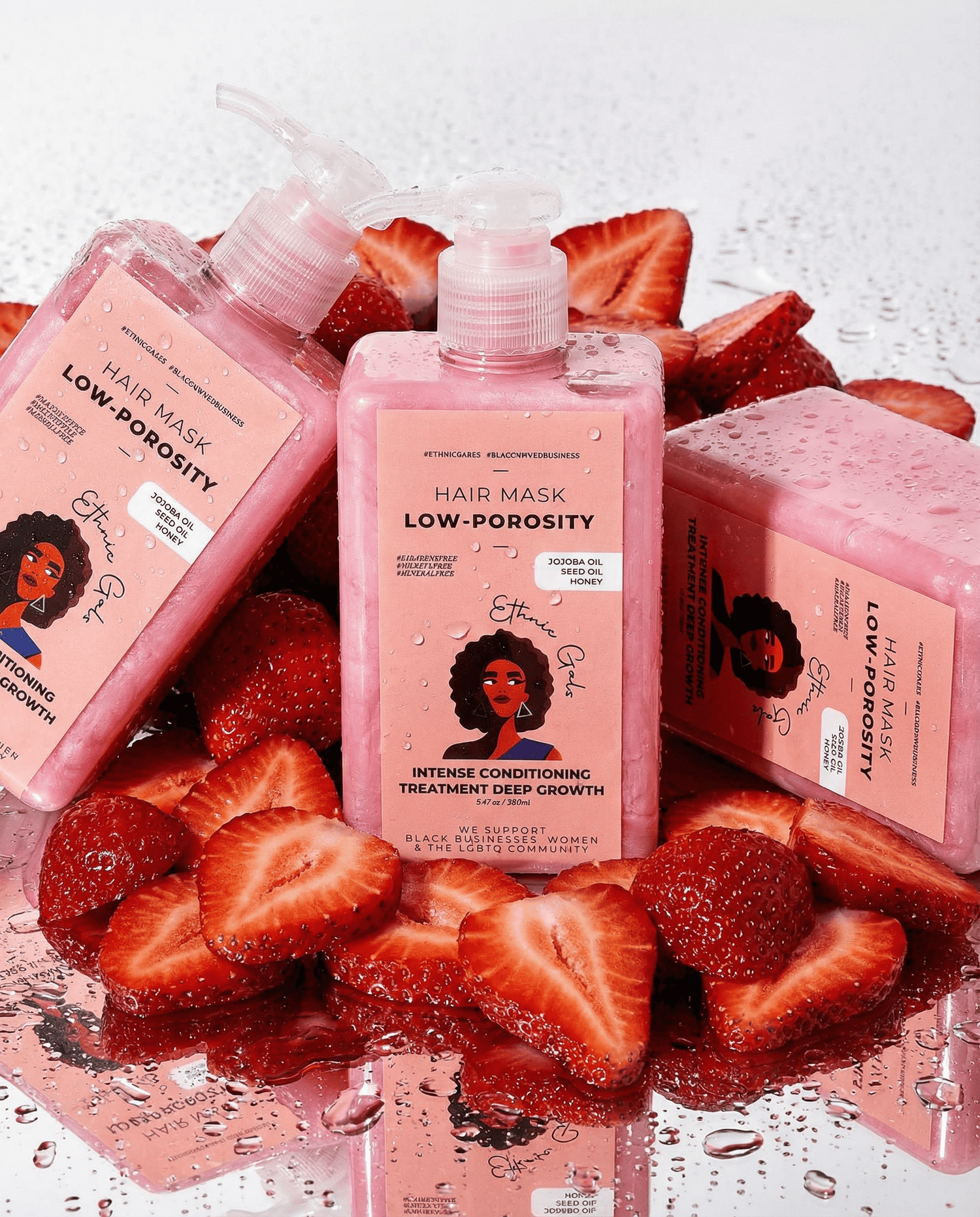 Hair mask bottles with strawberry slices on a white background