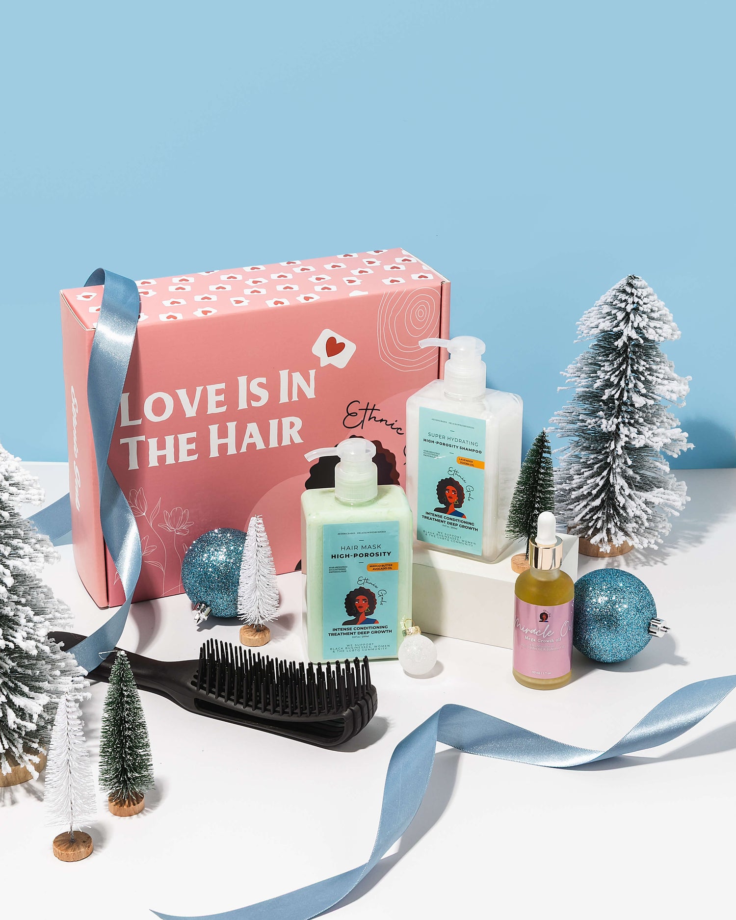 Cosmetic set with hair care products and a decorative box on a light blue background