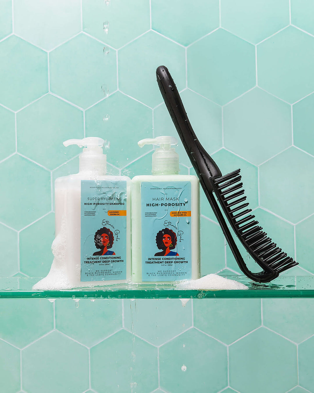 Two bottles of hair care products with a comb on a glass shelf against a green tiled wall.