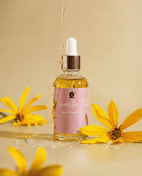 Bottle of Miracle Oil with a dropper surrounded by yellow flowers on a beige background